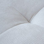 Close-up of a tufted design of a white sofa