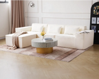 White sectional sofa in a living room with a coffee table and decor items.