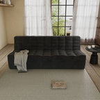 A black chenille waffle floor 3-seater sofa with a minimalist design, placed in a room with a window, curtains, and a small round table with an object on it.