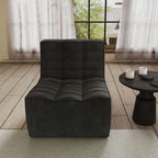 A black chenille accent chair with a minimalist design, positioned in a room with a window, curtains, and a small round side table.