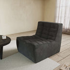 A black chenille accent chair with a minimalist design