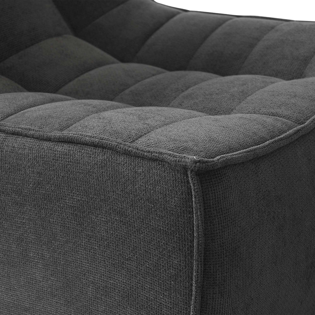 Close-up of a corner of a black waffle floor armchair