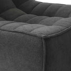Close-up of a corner of a black waffle floor armchair