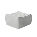 Light gray ottoman with tufted design on a white background