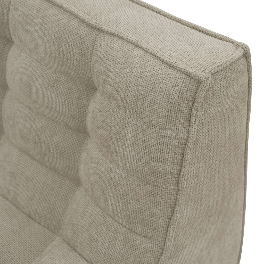 Close-up of a corner of a khaki waffle floor sofa