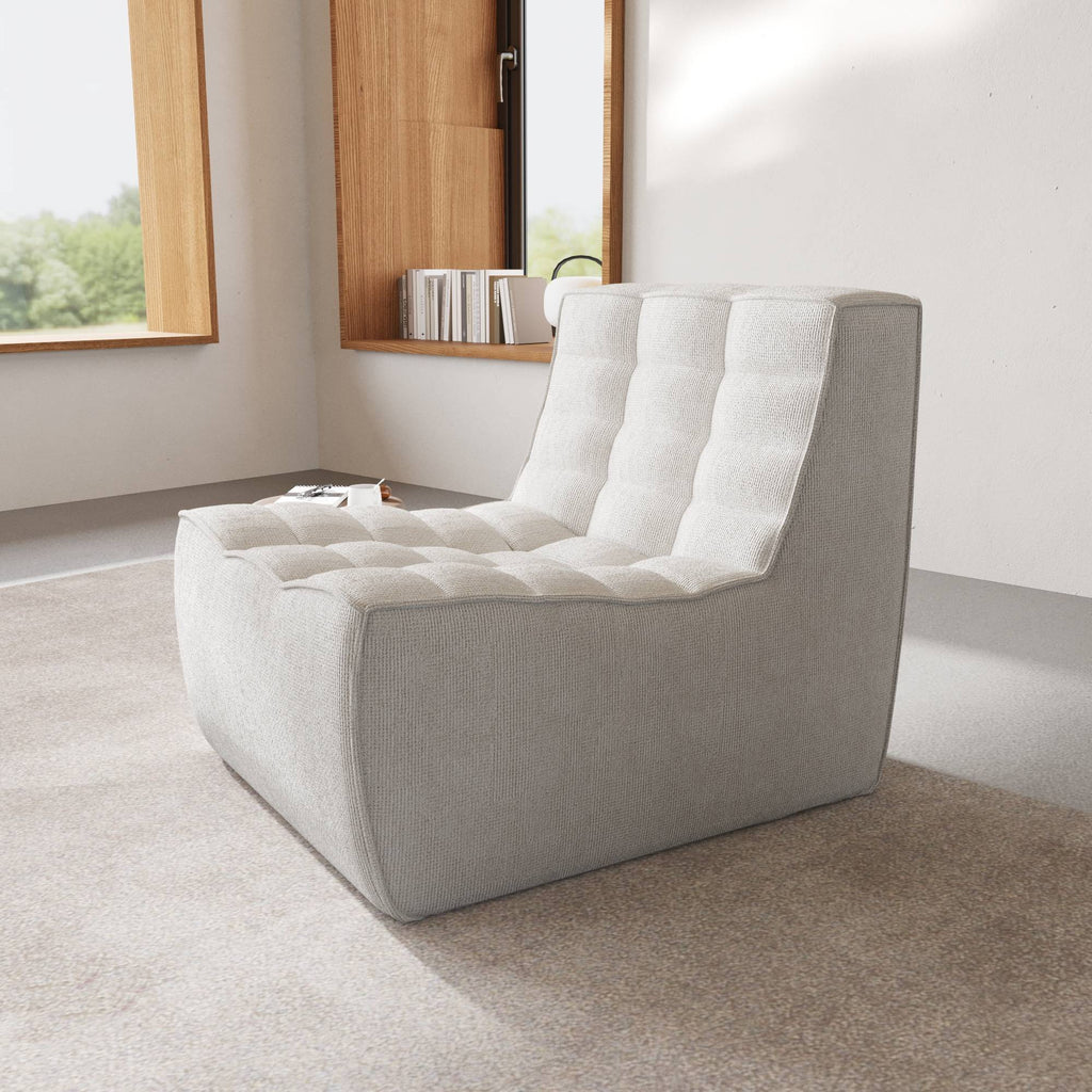 A light gray chenille accent chair with a minimalist design in a day light