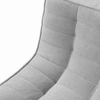 Close-up of a fabric of a gray tufted waffle sofa