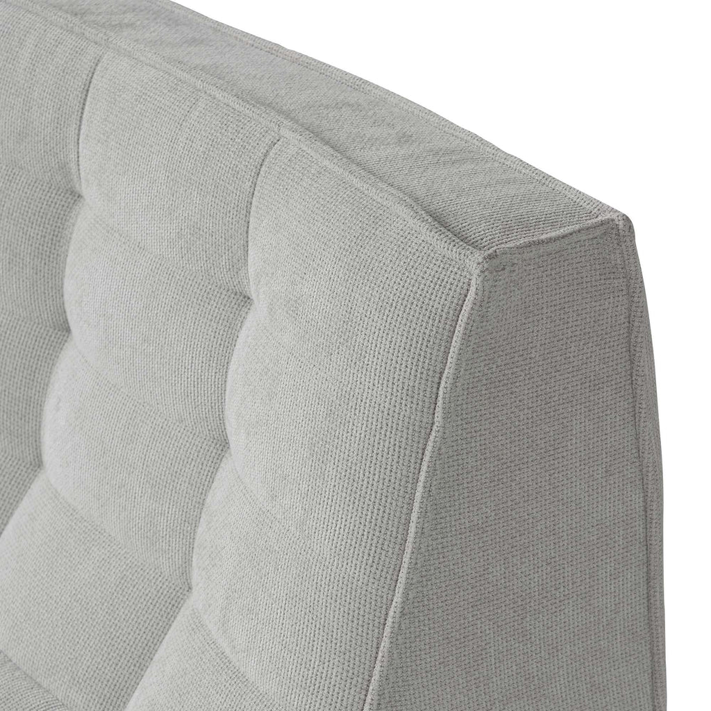 Close-up of a corner of a waffle gray sofa