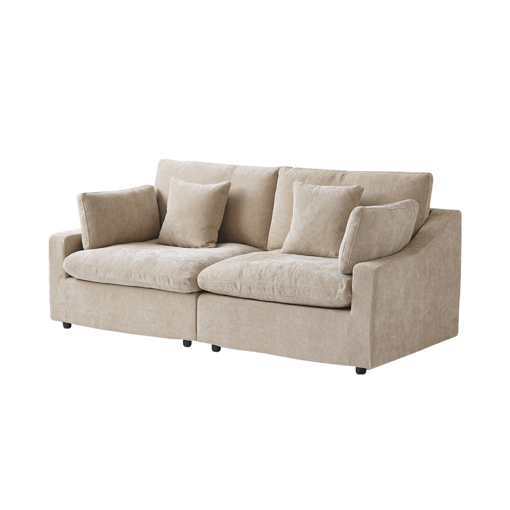 Beige sofa with four accent pillows on a white background