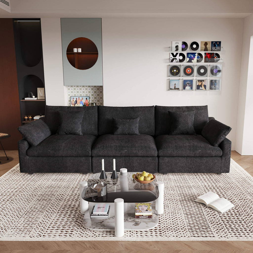A modern black 3-seater sectional sofa with washable cushions and pillow covers, placed in a room with a minimalist design.