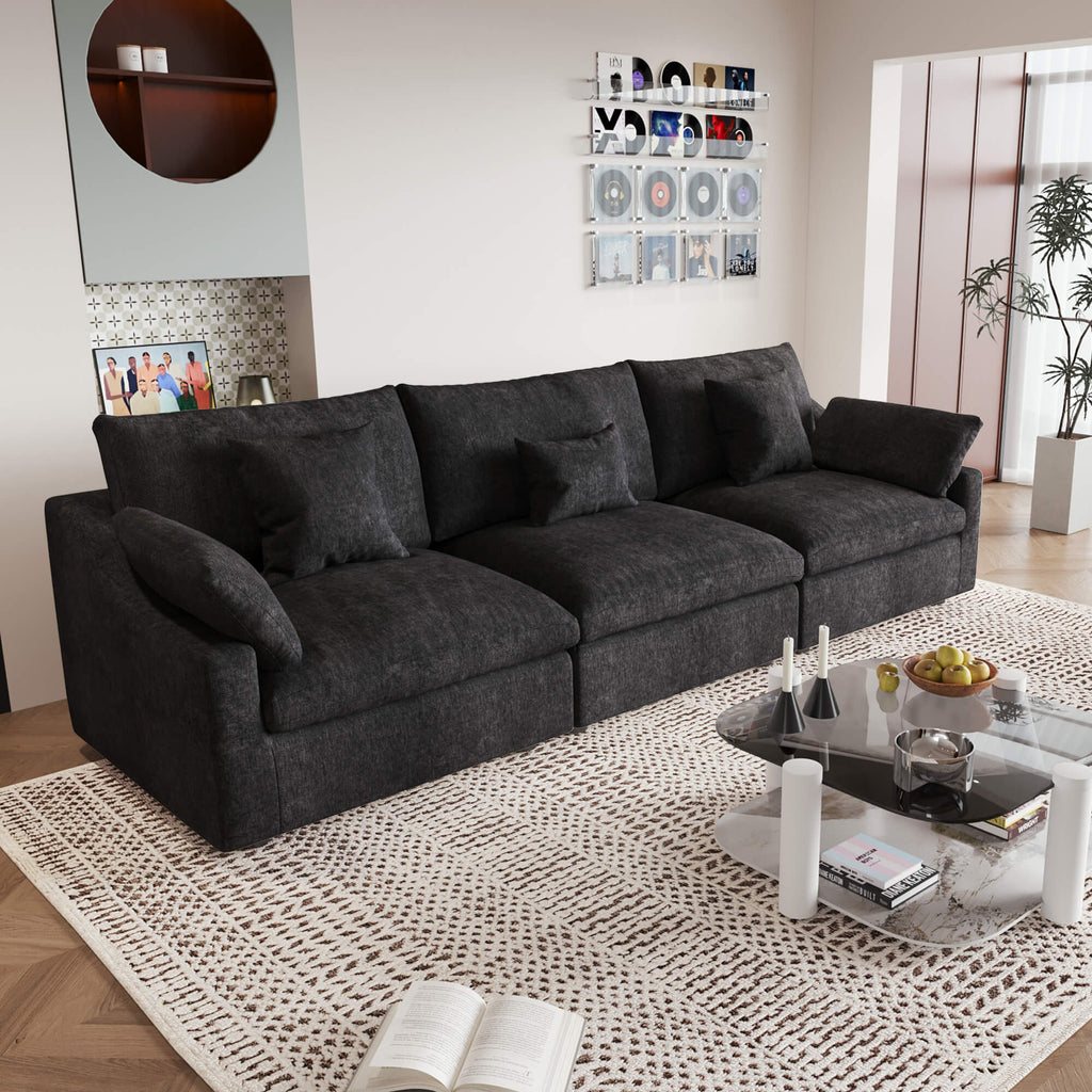 A modern black 3-seater sectional sofa with washable cushions and pillow covers, placed in a room with a minimalist design.