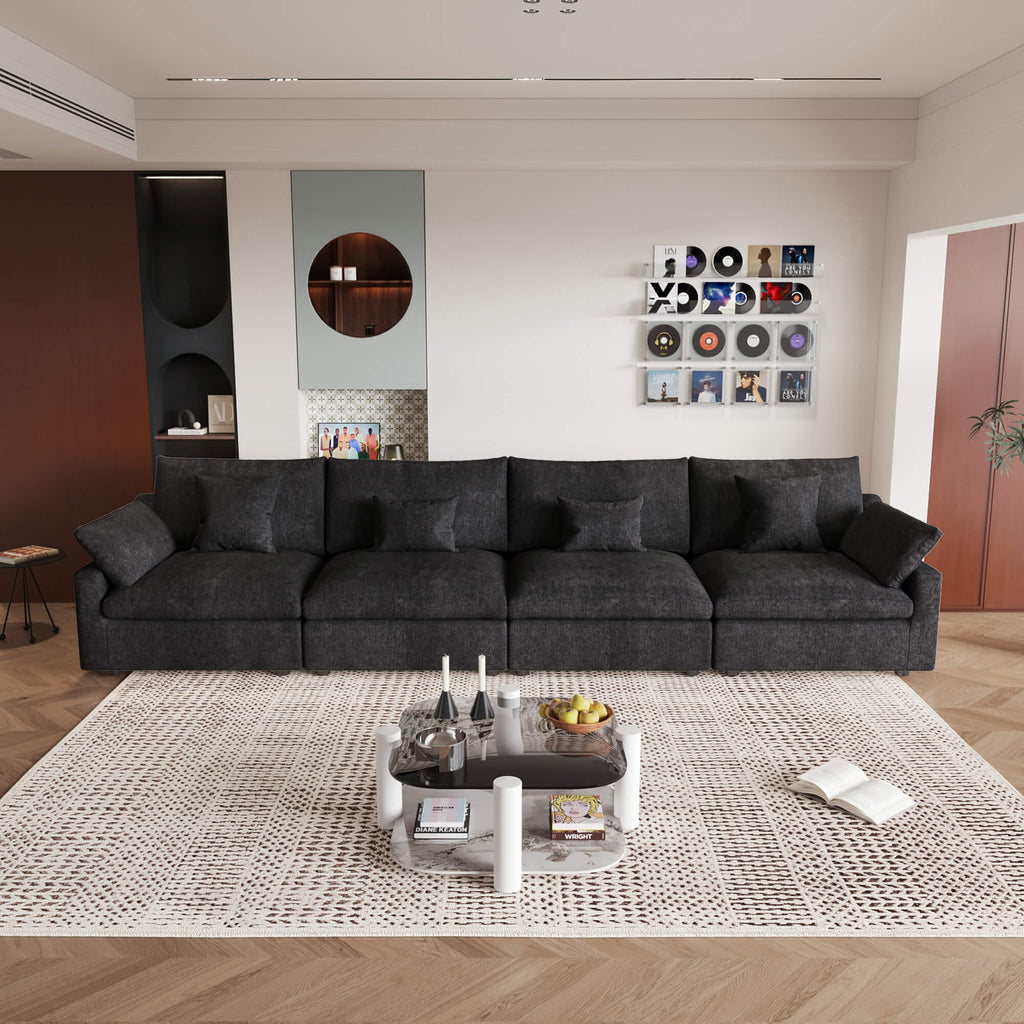 A black washable cloud sectional 4-seat sofa with removable cushions and pillow covers, arranged in a living room setting.