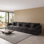 Modern living room with a large black 4-seat sectional sofa, coffee table, and decorative elements.