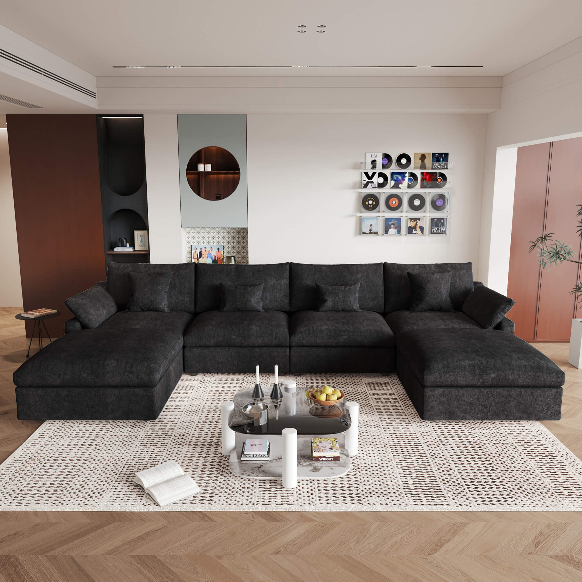 A large black U-shaped sectional sofa with removable cushions and pillow covers, placed in a modern living room setting.
