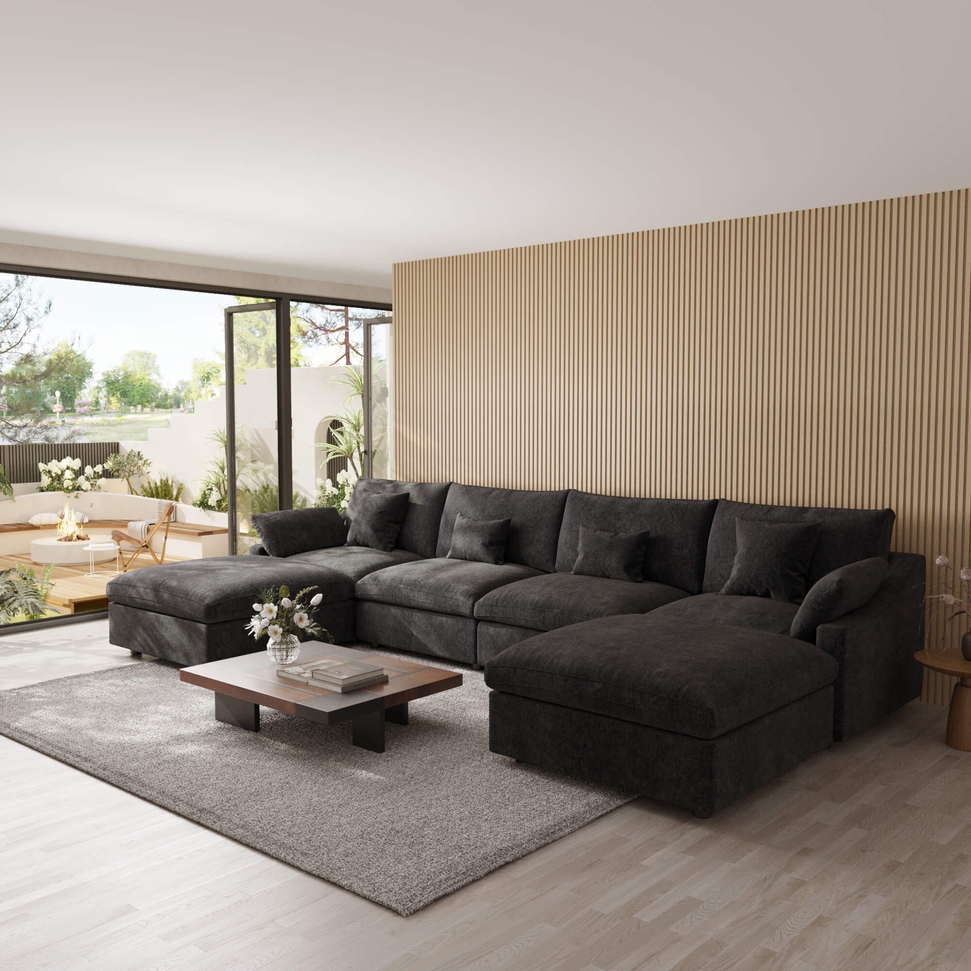 Modern living room with a black U-shaped sectional sofa, coffee table, and decorative elements.