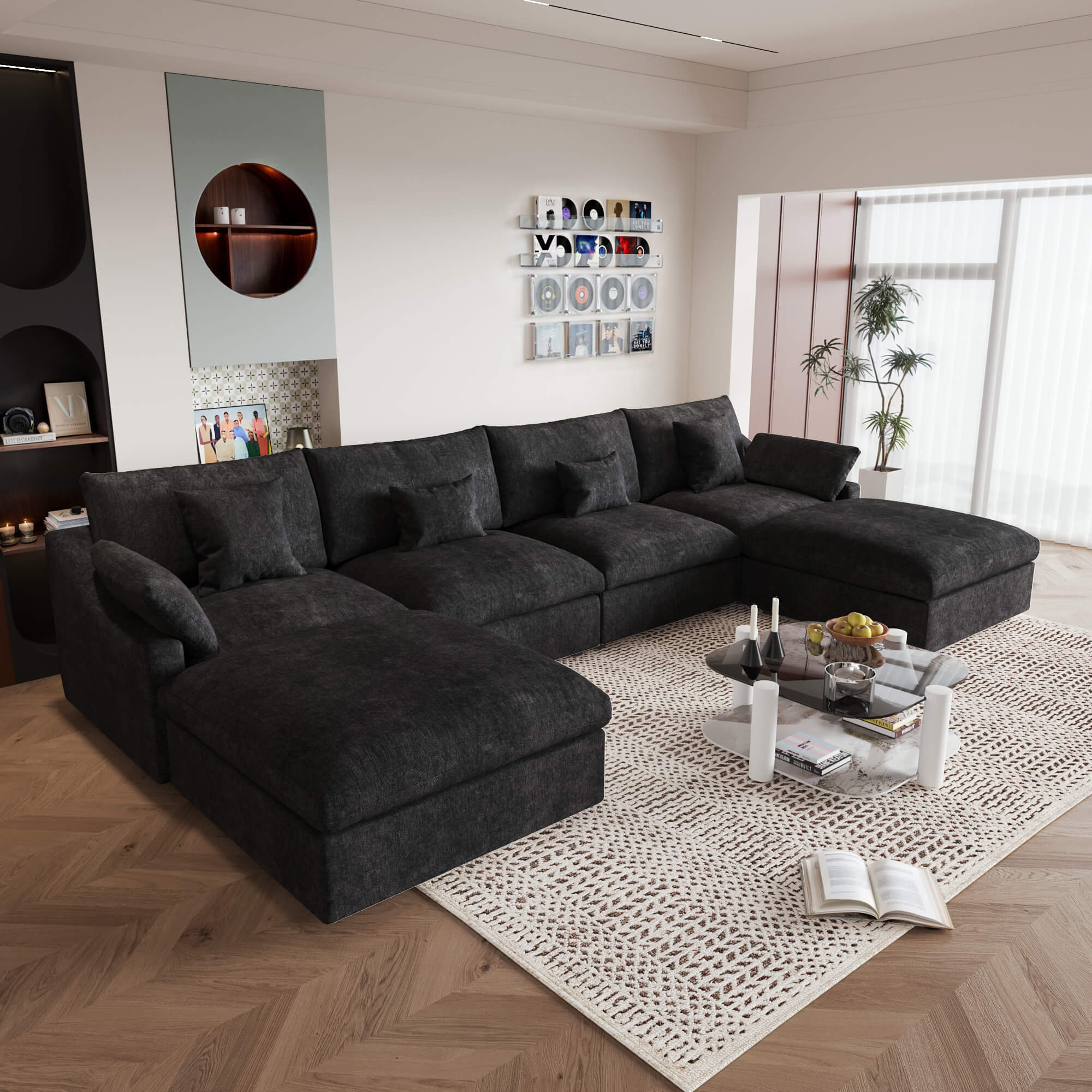 A large black U-shaped sectional sofa with removable cushions and pillow covers, placed in a modern living room setting.
