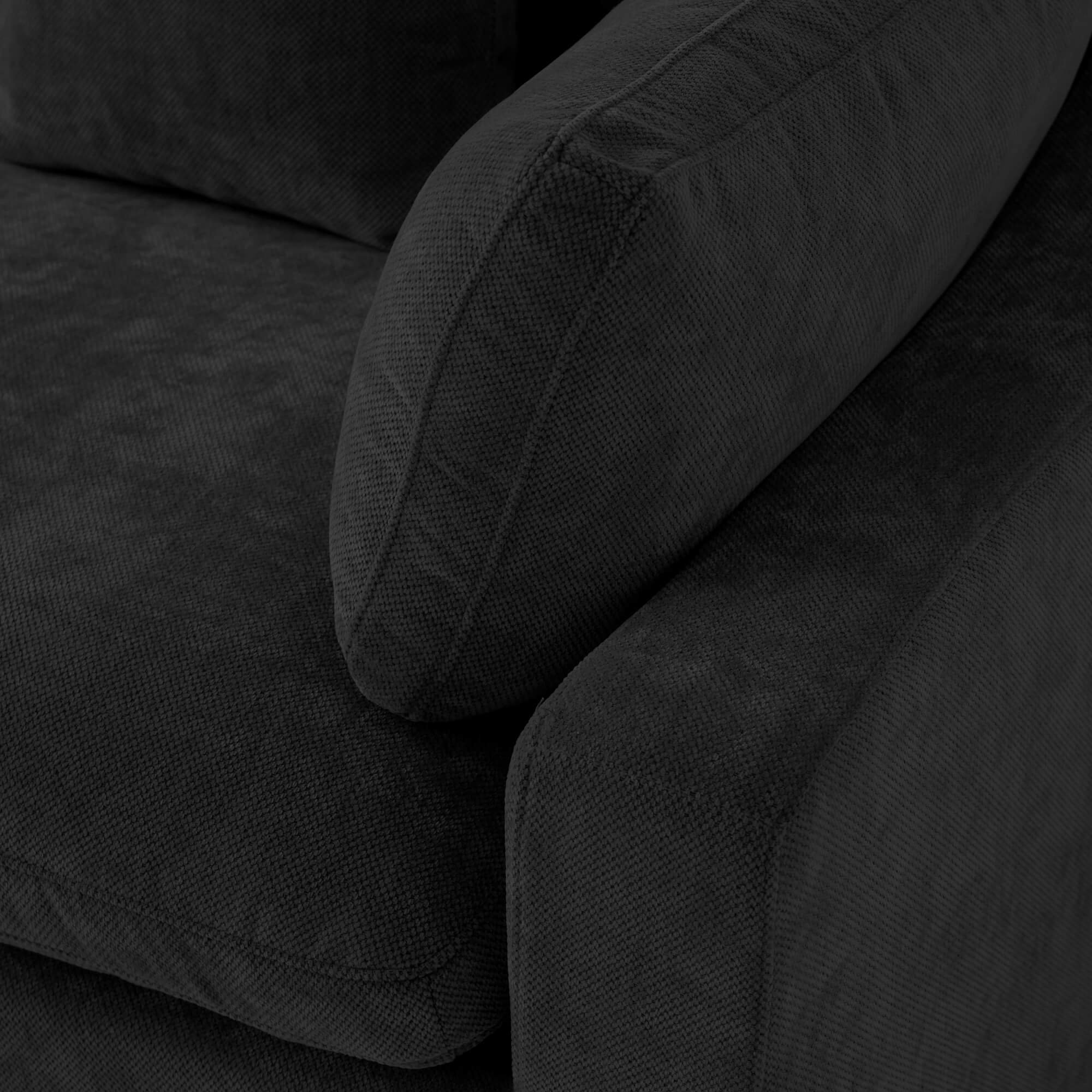 Close-up of a corner of a seat of a black sofa