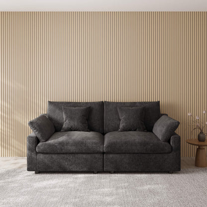 Black loveseat couch in a room with a striped wall and small table.