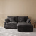 Black sectional chaise lounge loveseat in a room with striped wallpaper