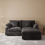 Black sectional chaise lounge loveseat in a room with striped wallpaper