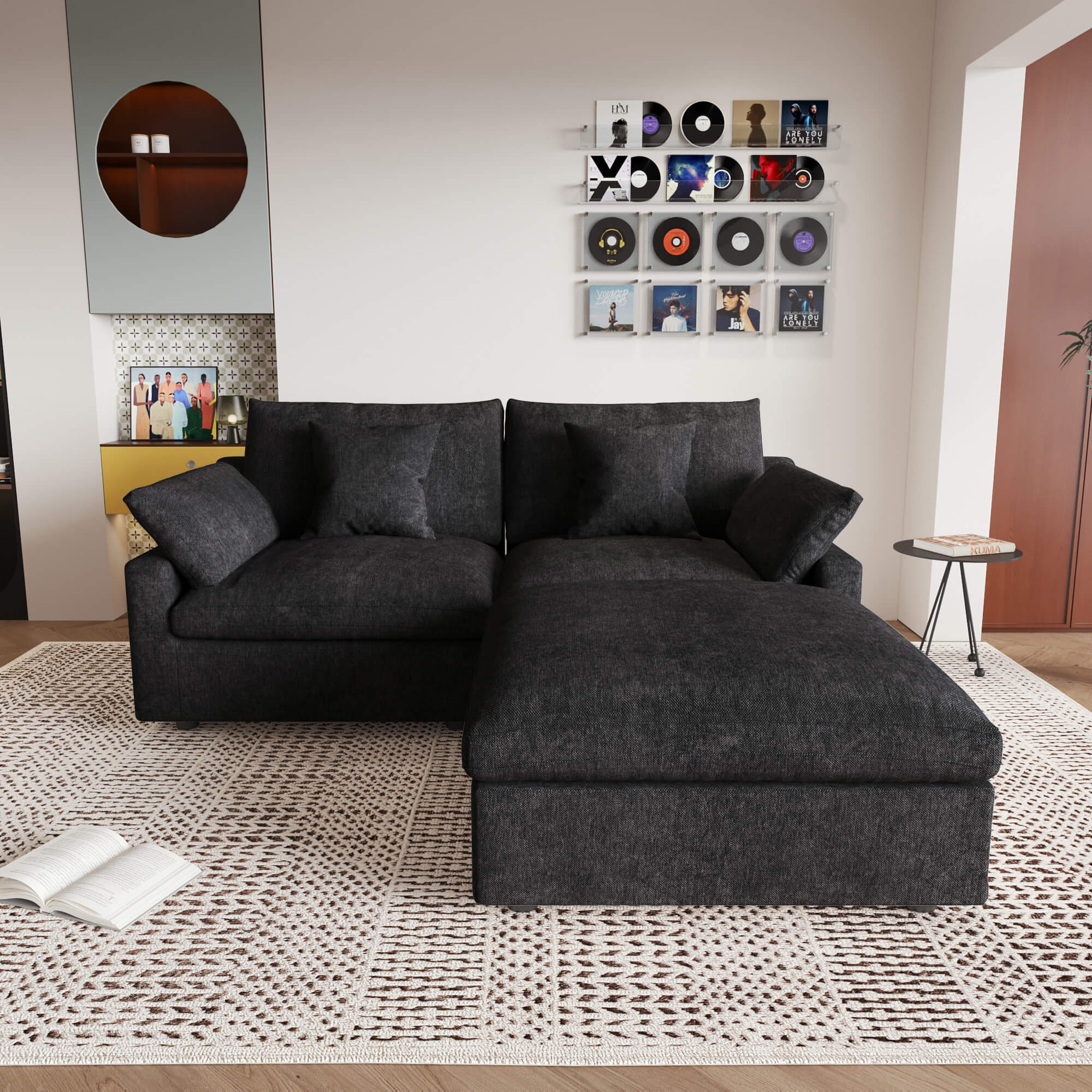 A black linen loveseat with ottoman, featuring a washable cloud design, placed on a patterned rug in a room with a record collection on the wall.