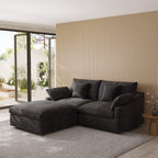 Black sectional sofa in a modern living room with a striped wall and patio door.
