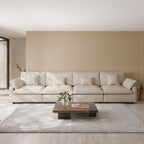 Khaki 4-seat sectional sofa in a modern living room with a coffee table and decorative elements.