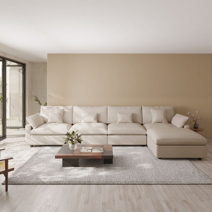 Modern living room with a khaki 5-seat sectional sofa with ottoman, wooden coffee table, and striped wall.