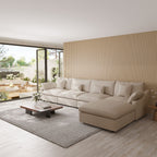 Khaki 5-seat sectional sofa with ottoman in a modern living room with large windows and a striped wall.