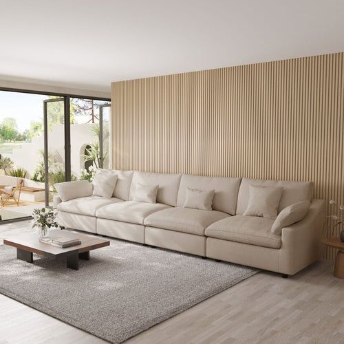 Khaki 4-seat sectional sofa in a modern living room with a striped wall and large windows.