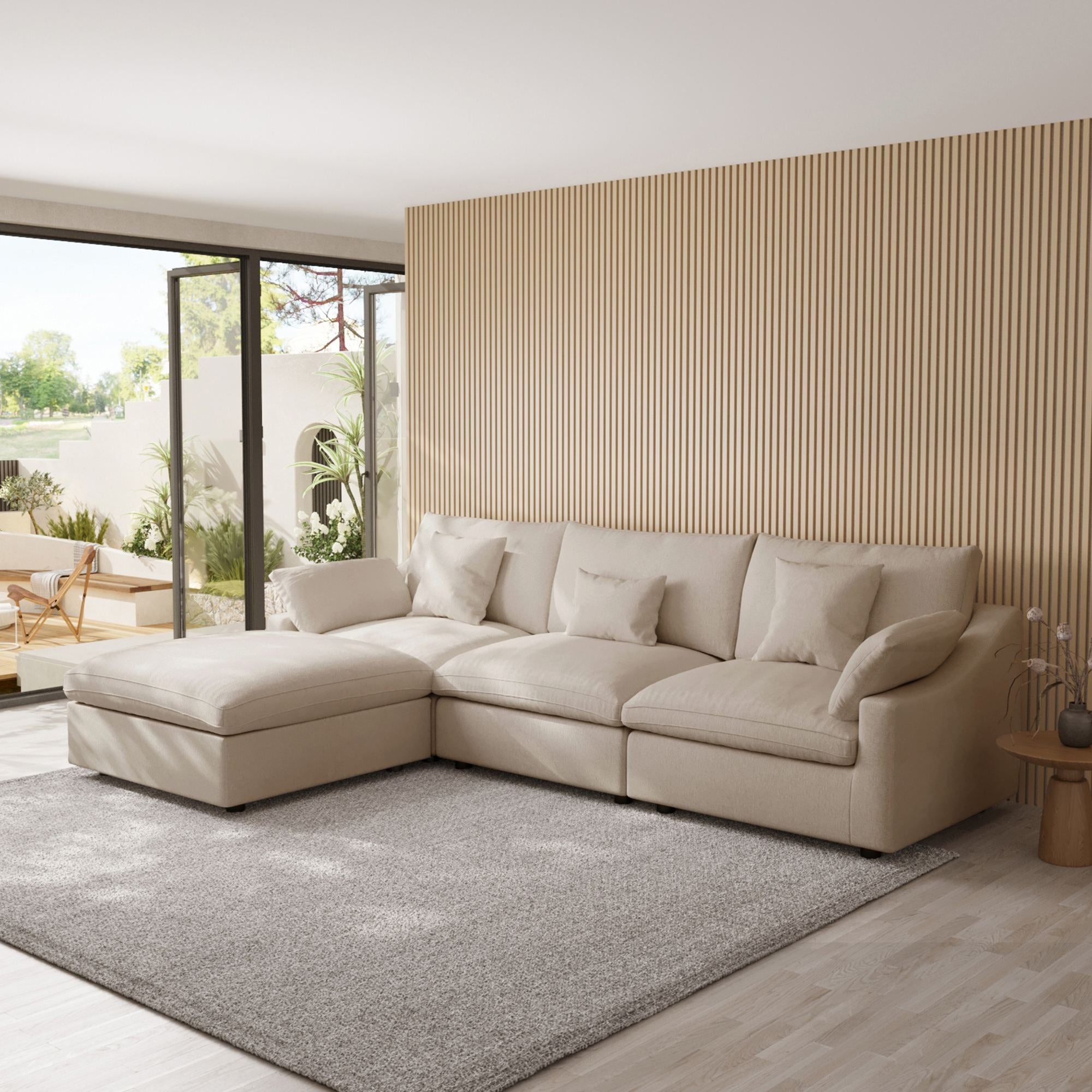 Khaki L-shaped sectional sofa in a modern living room with large windows and striped wall.