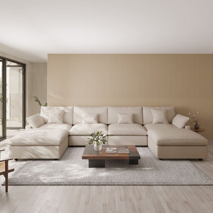 Khaki U-shaped sectional sofa in a modern living room with a striped wall and wooden coffee table.