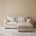 Khaki sectional chaise lounge sofa in a room with striped wallpaper