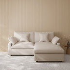 Khaki sectional chaise lounge sofa in a room with striped wallpaper