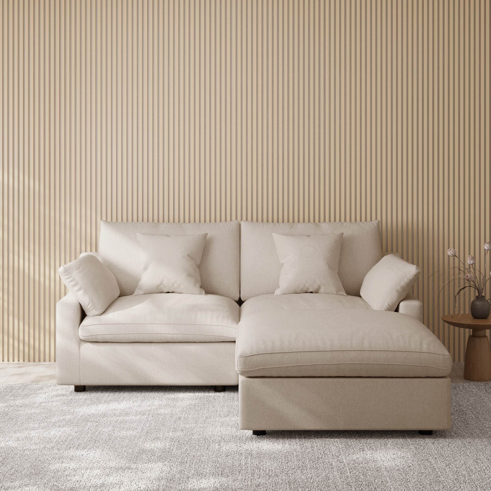 Khaki sectional chaise lounge sofa in a room with striped wallpaper