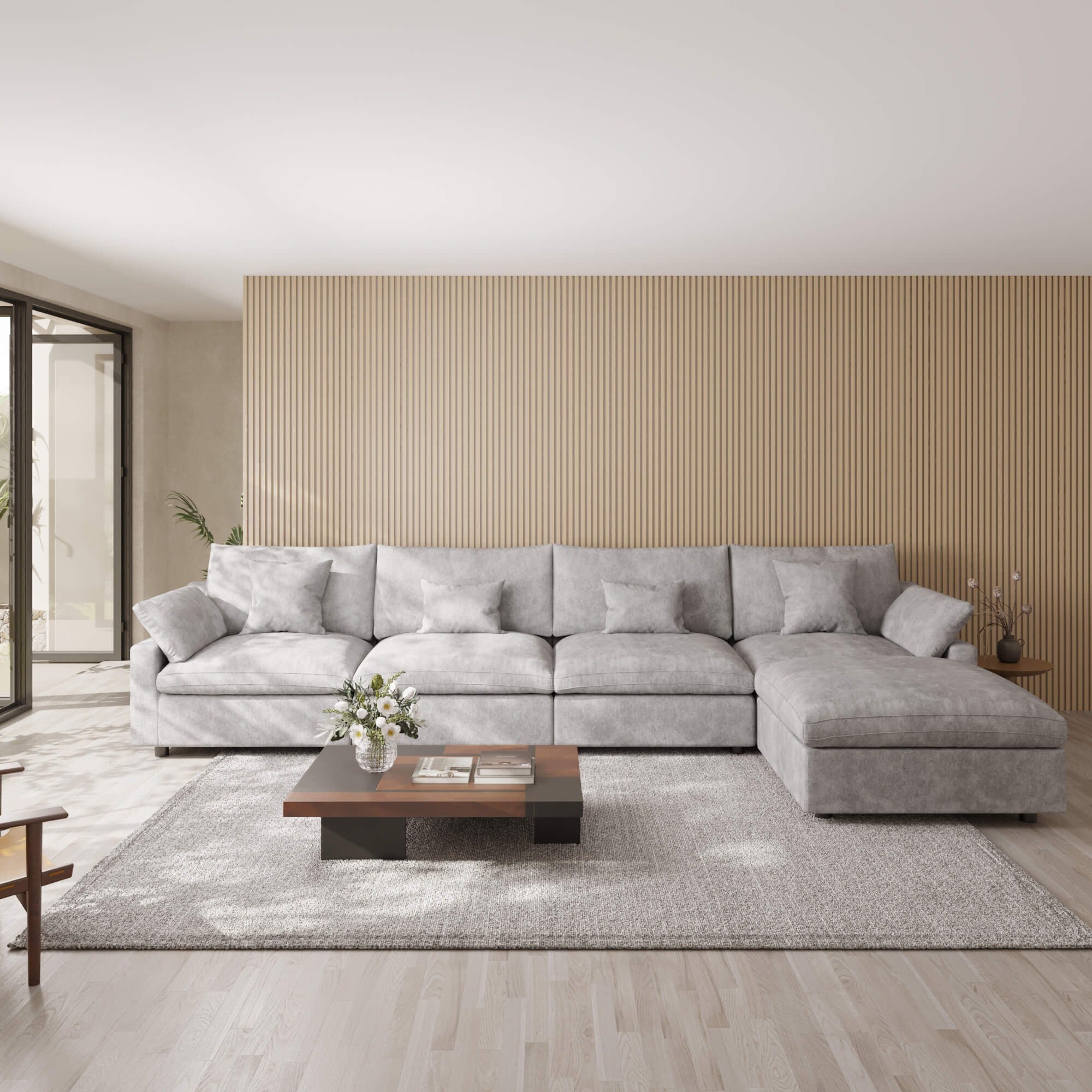 Light gray 5-seat sectional sofa with ottoman in a modern living room with a wooden coffee table and decorative elements.