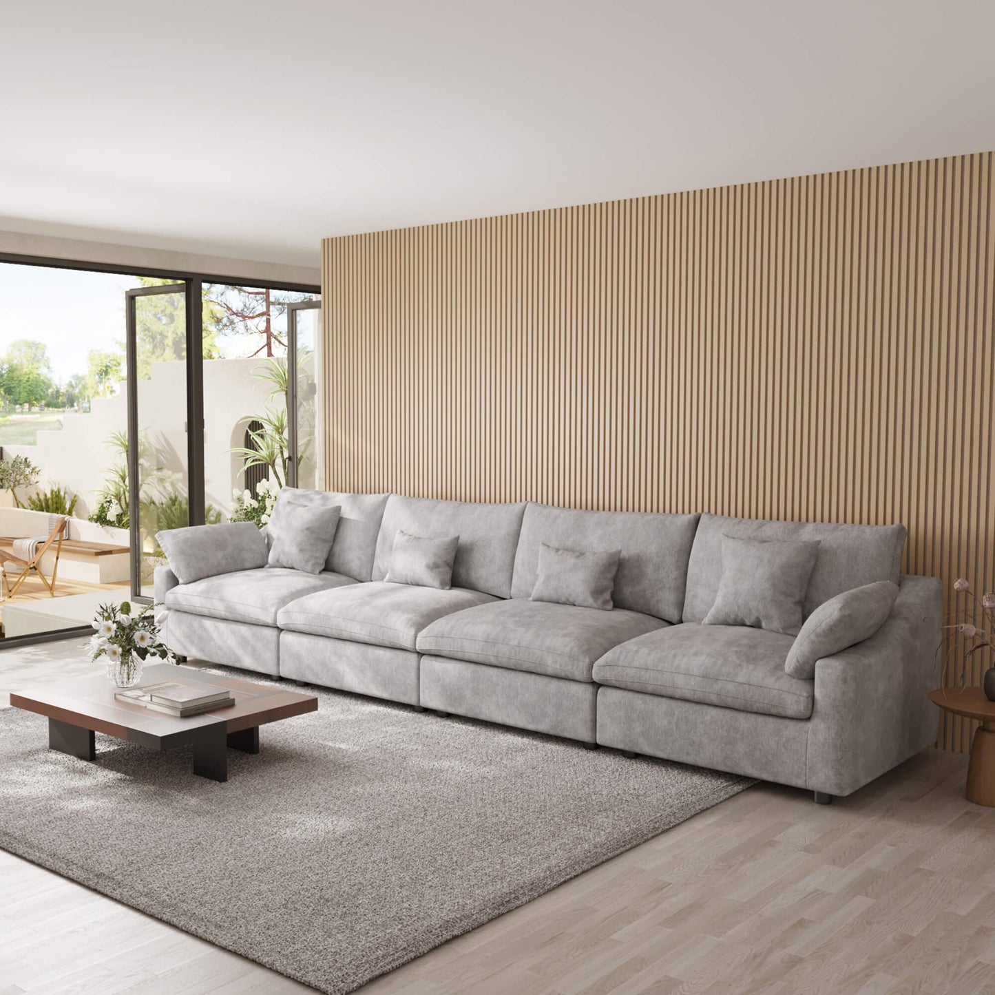 Light gray 4-seat sectional sofa in a modern living room with a wooden coffee table and decorative elements.