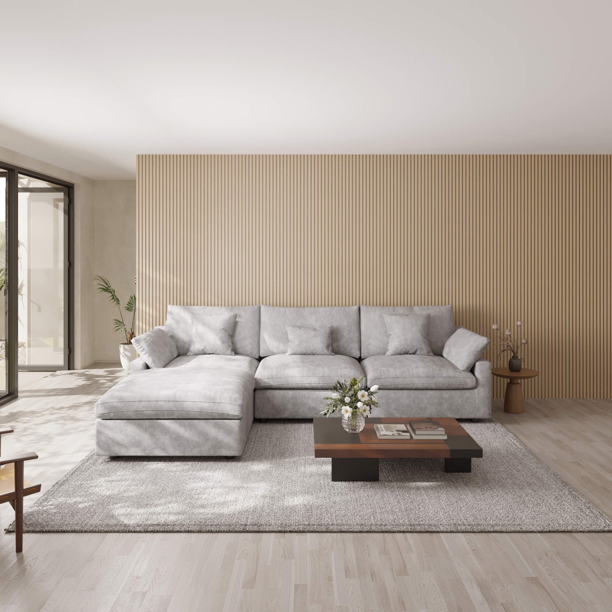 Modern living room with a light gray L-shaped sectional sofa, wooden coffee table, and striped wall.