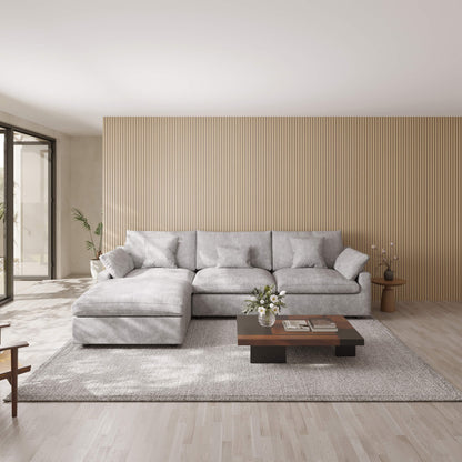 Modern living room with a light gray L-shaped sectional sofa, wooden coffee table, and striped wall.