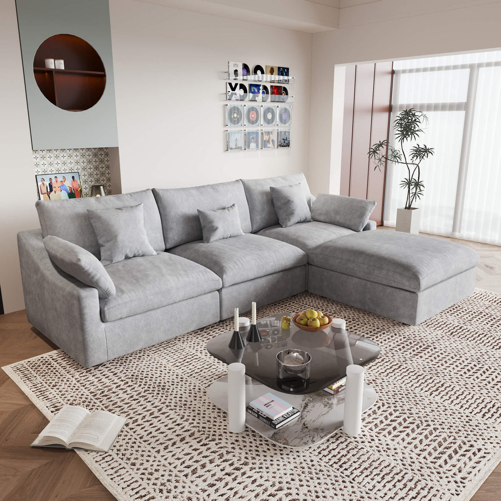 An L-shaped light gray sectional sofa with removable cushions and pillow covers, placed in a living room setting.