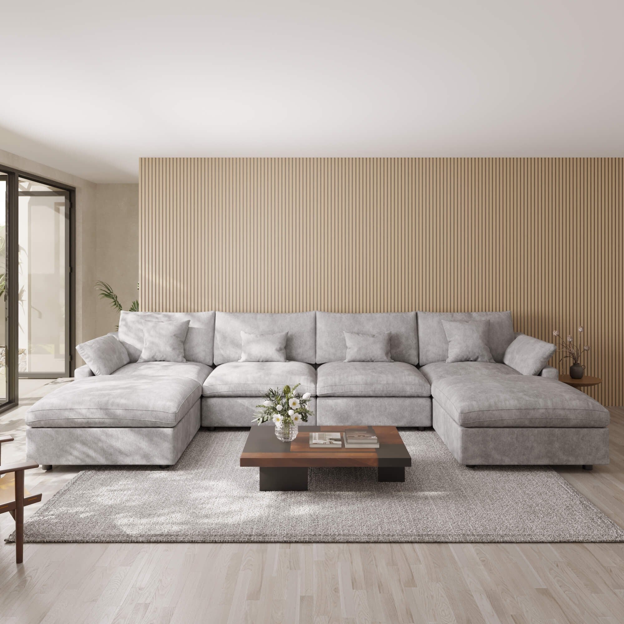 Light gray U-shaped sectional sofa in a modern living room with a wooden coffee table and decorative items.