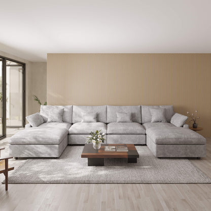 Light gray U-shaped sectional sofa in a modern living room with a wooden coffee table and decorative items.