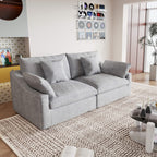 A light gray loveseat couch, featuring a minimalist design with removable cushions, placed in a room with modern decor.