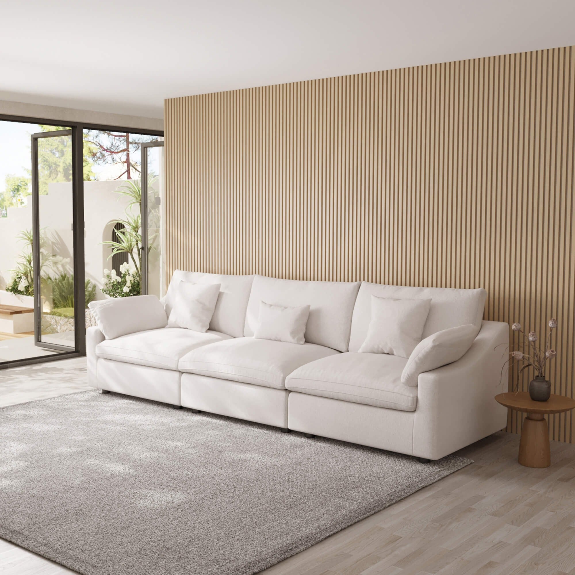 White White 3-seater sofa in a modern living room with a wooden accent wall.
