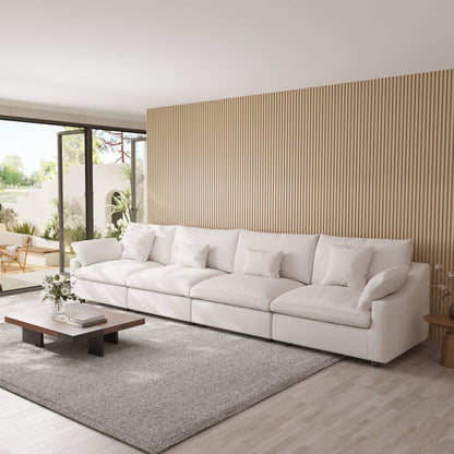 Modern living room with a white 4-seat sectional sofa, coffee table, and decorative elements.