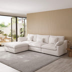 White L-shaped sectional sofa in a modern living room with a striped wall and sliding glass doors.