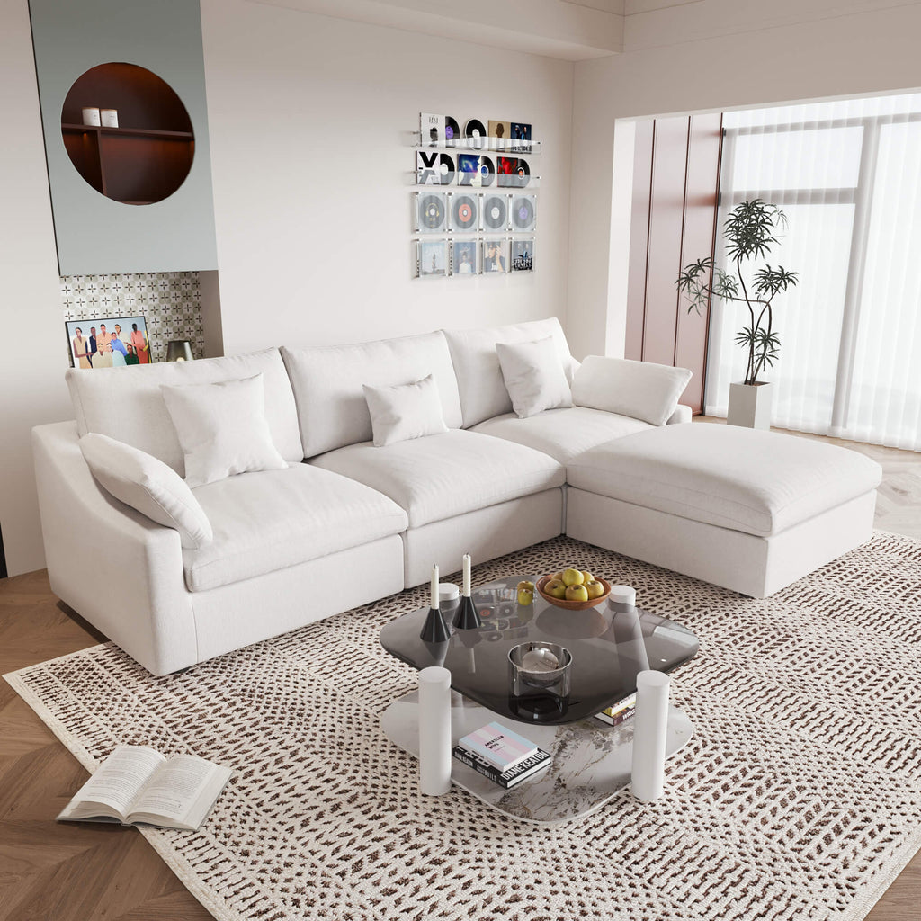 An L-shaped white sectional sofa with removable cushions and pillow covers, placed in a living room setting.