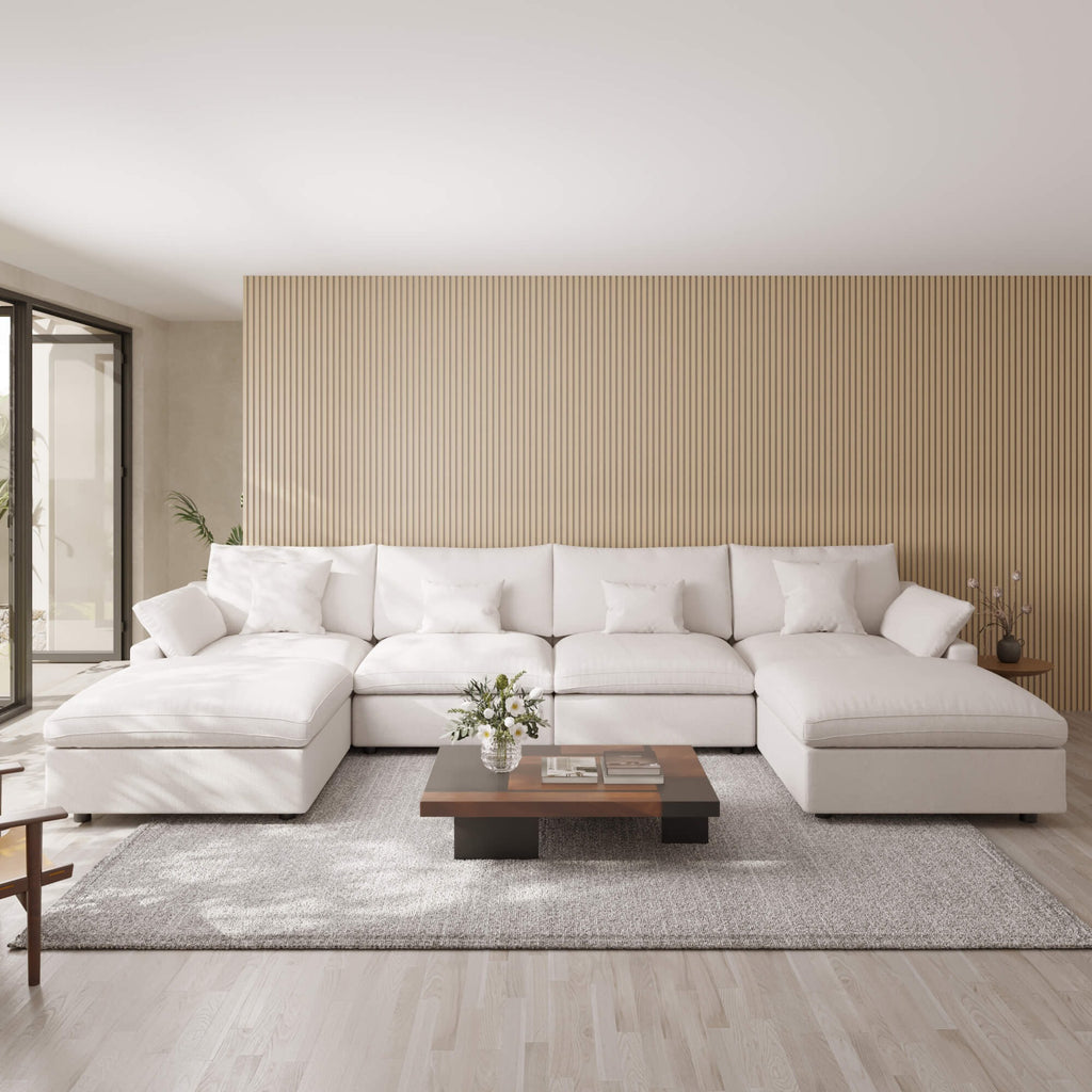 Modern living room with a khaki U-shaped sectional sofa, wooden coffee table, and striped wall.