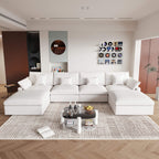 A large white U-shaped sectional sofa with removable cushions and pillow covers, placed in a modern living room setting.