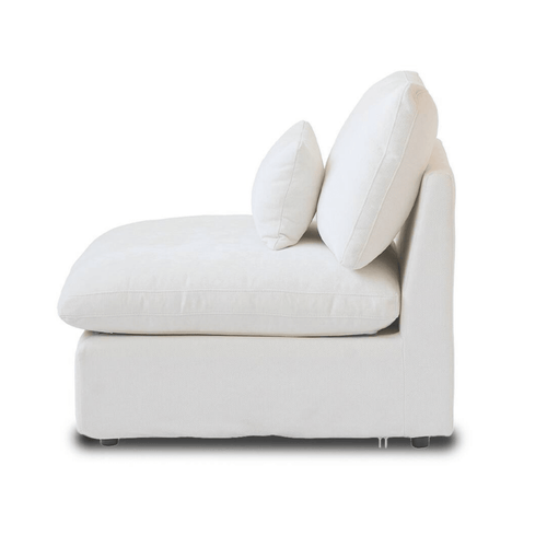 White linen-cotton armless chair with washable covers and accent pillow, side view.